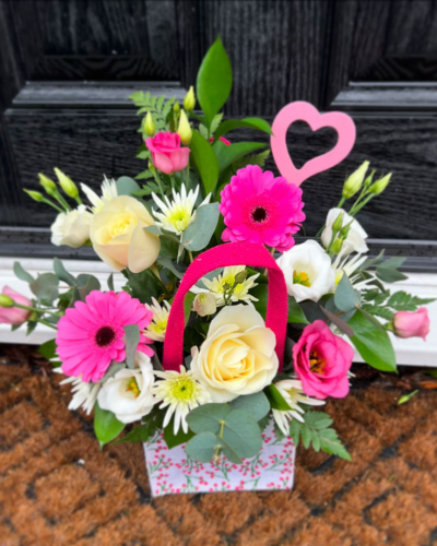 A Little Something - Show your affection with this mouth-watering mix of classical flowers delivered in a delightful gift bag or box.