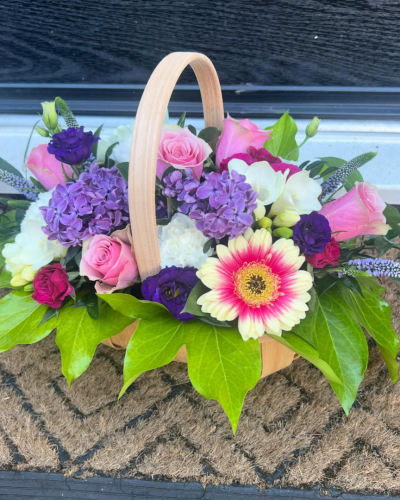 Bon Bon - Shower them with love with this cutesy collection of seasonal flowers in pretty pastels. Beautifully arranged and stylishly presented in a traditional basket.