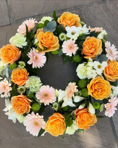 Wreath SYM-317 - A classic wreath arranged using mixed flowers.