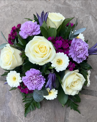 Posy SYM-345 - A classic funeral posy arranged with love using purple, lilac and white flowers.