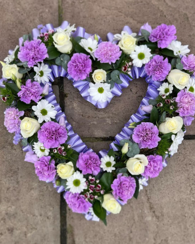 Heart SYM-325 - A beautiful open heart made with a selection of pink flowers specially chosen to make a stunning tribute by our florists.