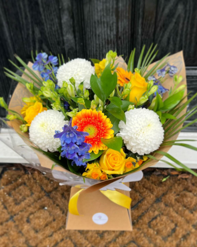 Citrus Sunrise - Capture the essence of a golden meadow with this stunning bouquet of yellow, white, and orange flowers. Presented in a stylish packaging it's perfect for adding natural beauty to any space